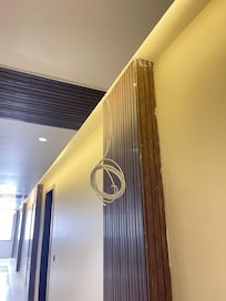 Exposed wires in the hallway posing electrocution risk