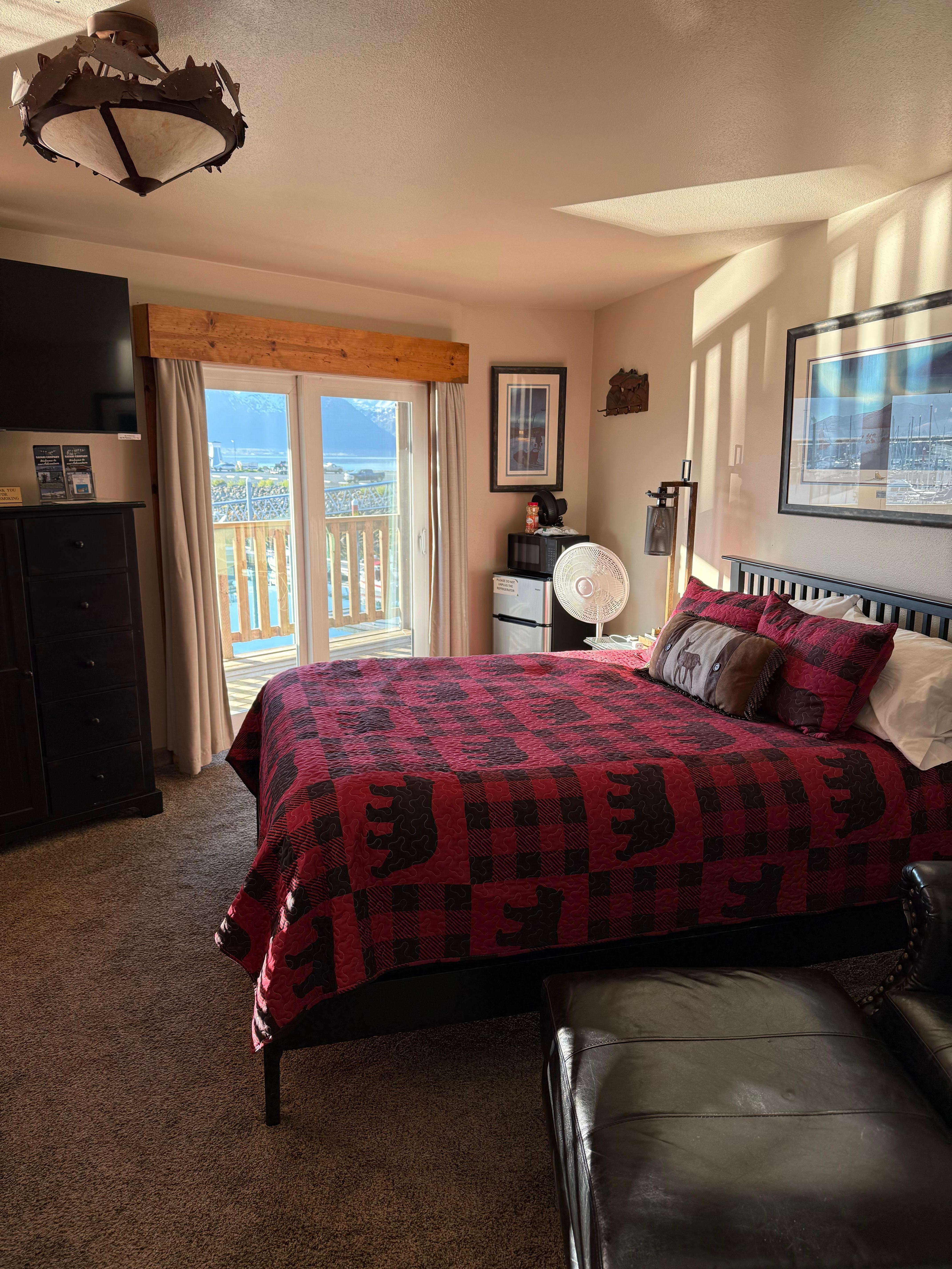 Inside the room. Another bed and window are not shown.