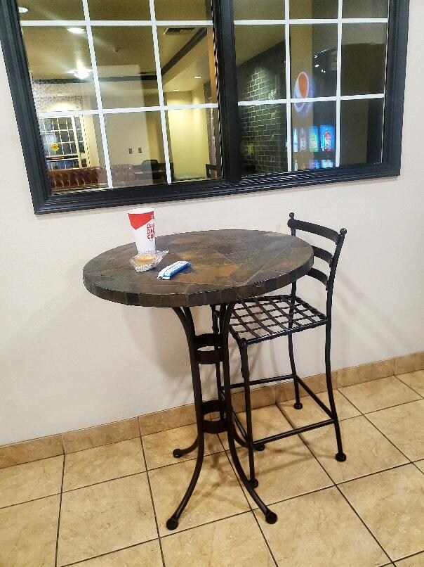 One table and one chair in  breakfast area.