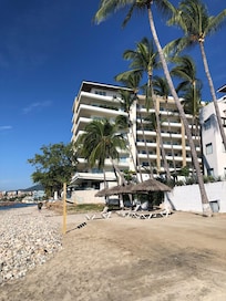 Lovely quiet sandy beach front location with private loungers including bar service