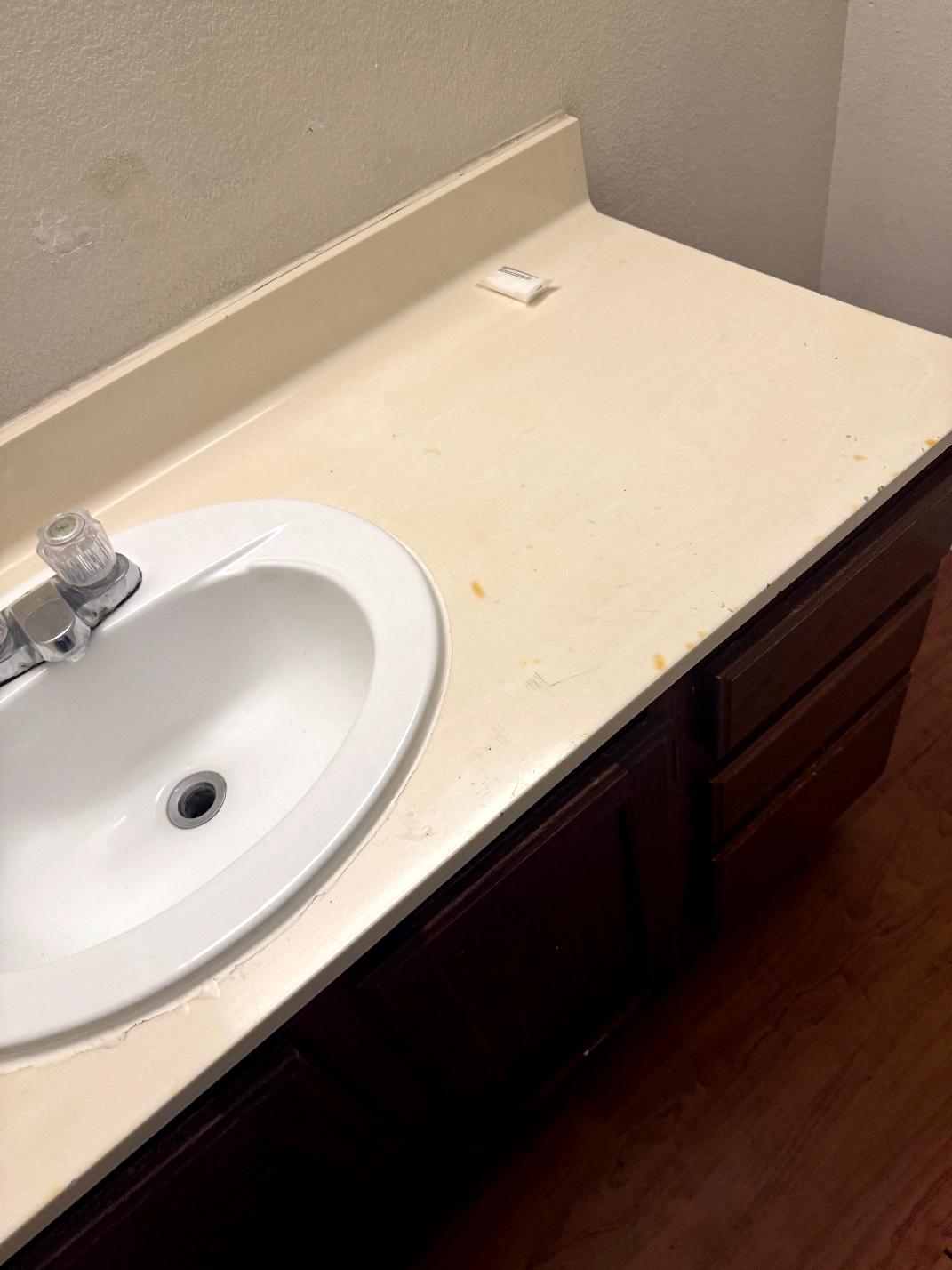 Cigarette burns on bathroom vanity