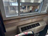 Unfinished wood windowsill that is also dirty