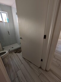 One of the doors (but both doors were the same). A broken door that has been attempted to be repaired. Zoom in to see that this is clearly a smashed door that has been plastered over very poorly.