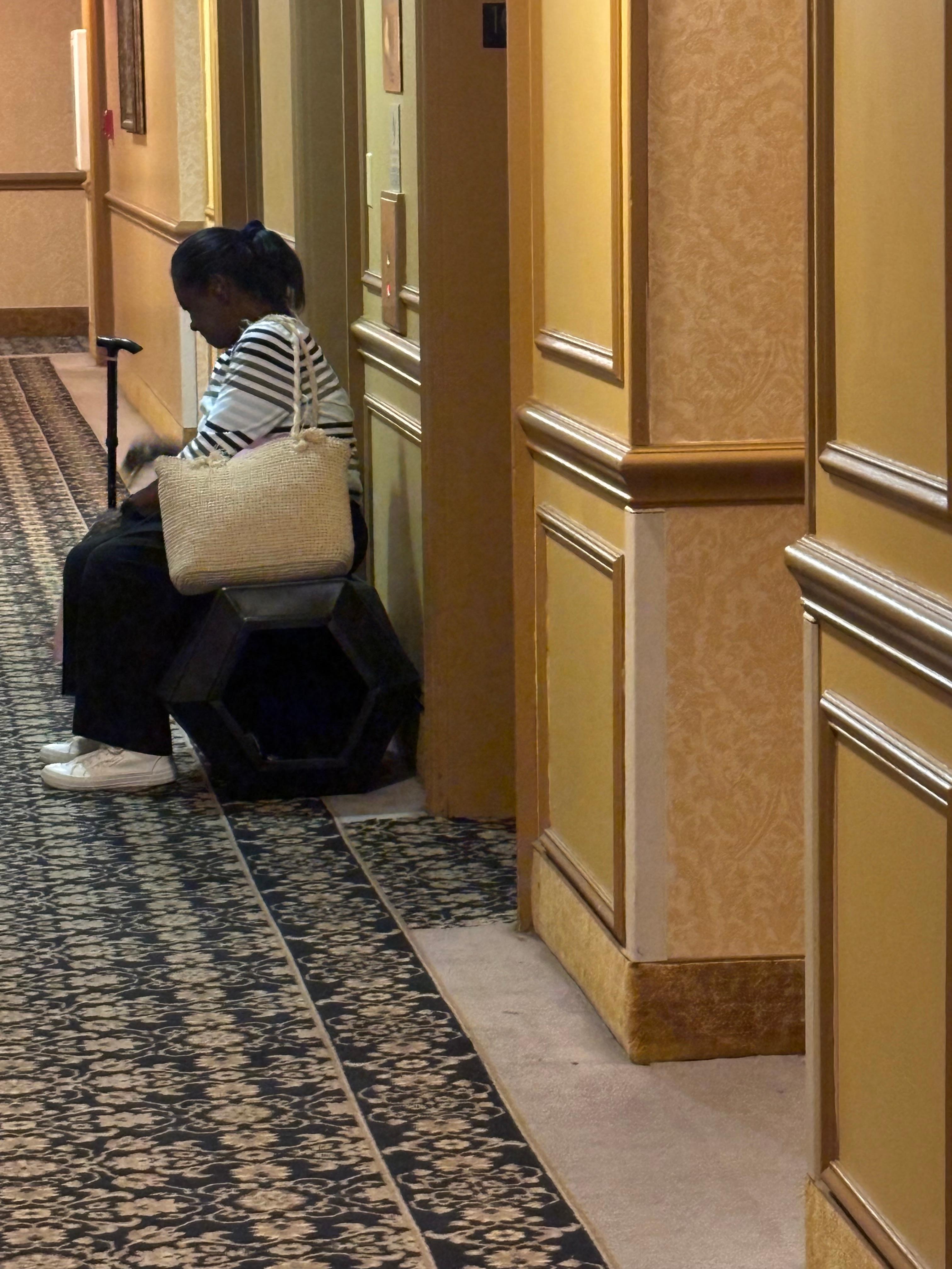 Handicapped mom sitting on overturned trash can because the elevators are so slow. We waited 30 minutes!