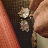 Trash behind the couch