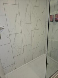 The shower on had one side with a door and the floor would get wet when taking a shower.