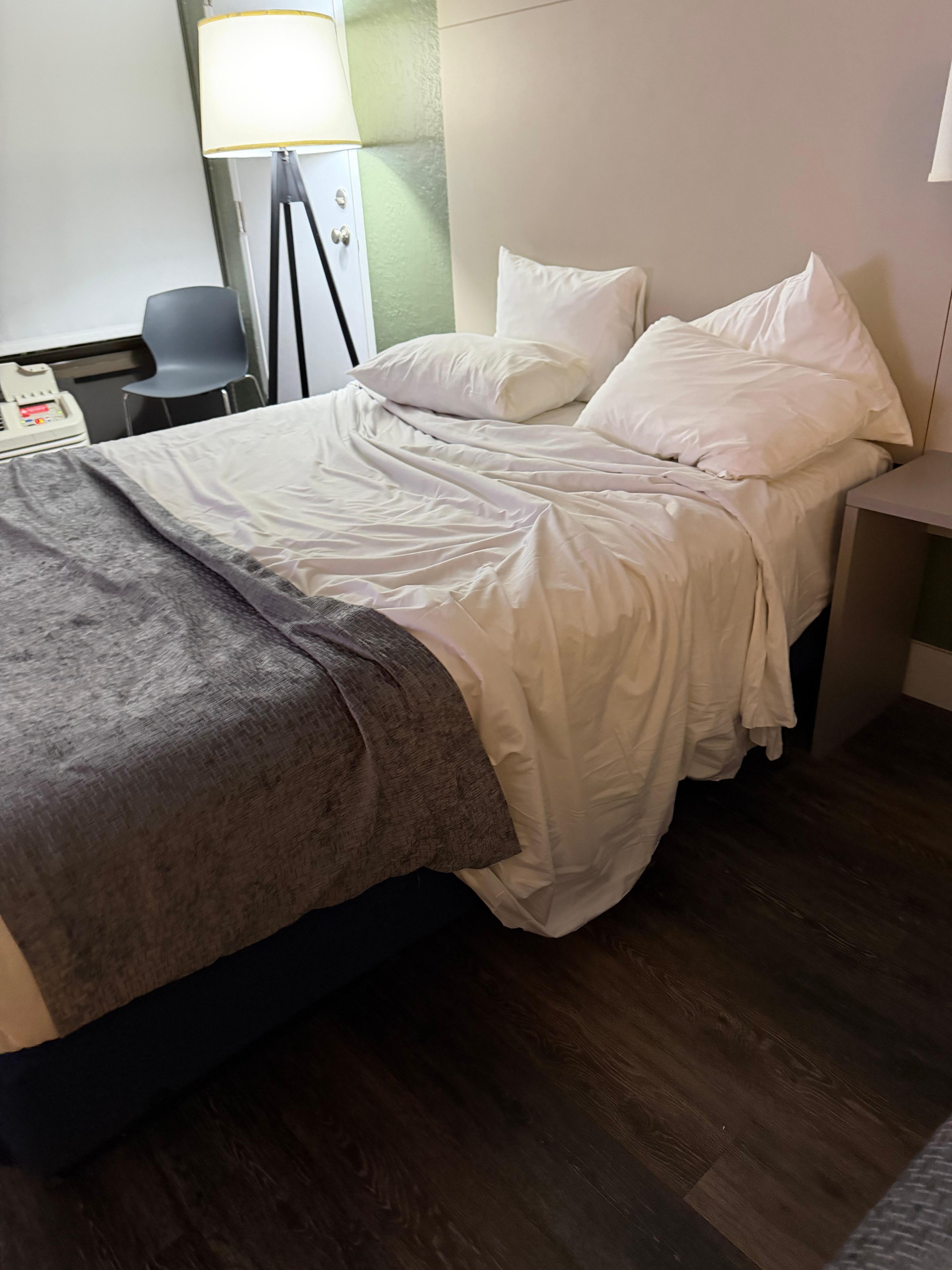 Unmade bed of the room that I was given when I came to this hotel 