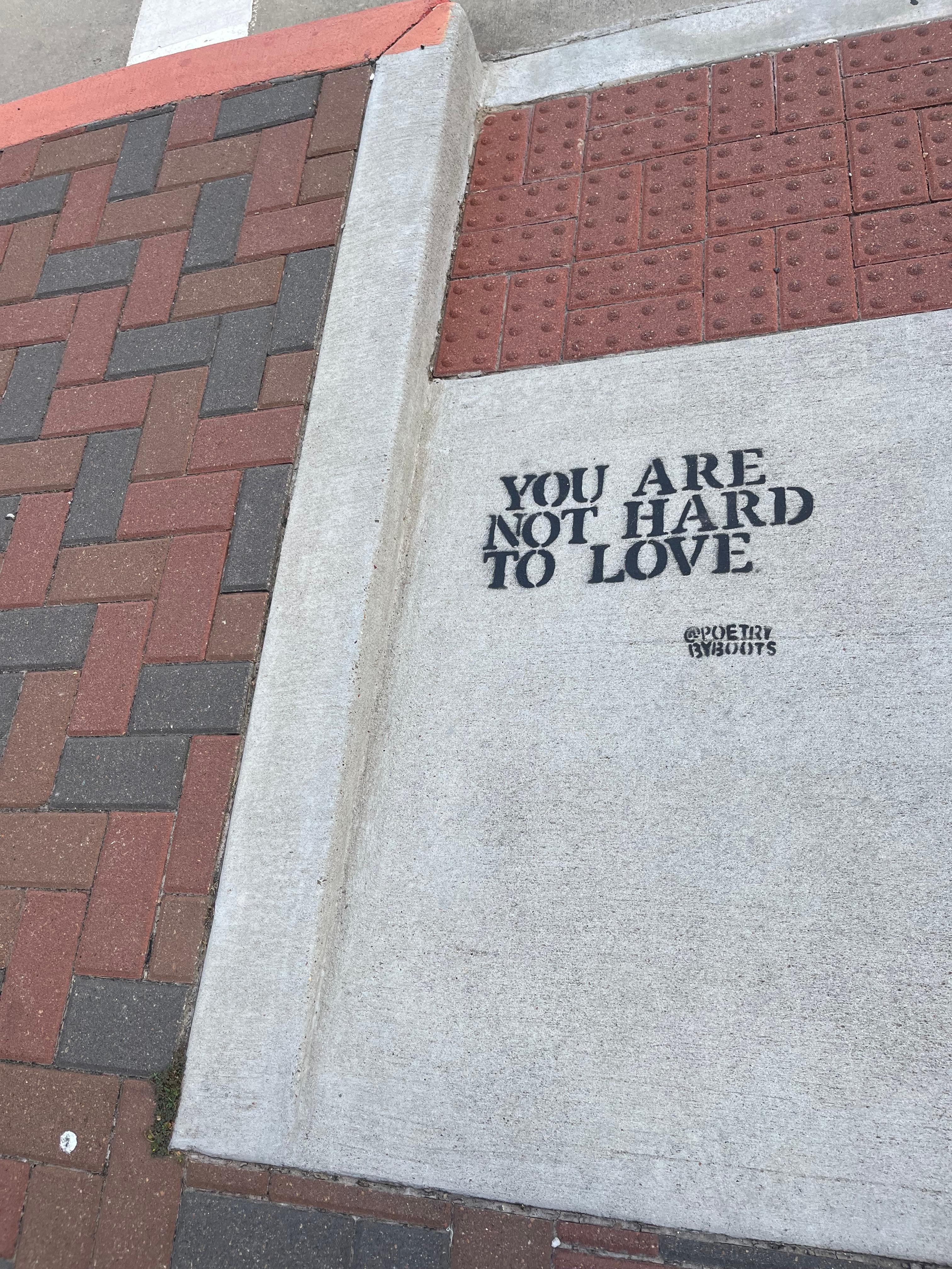 Words to live by are randomly painted on the street.