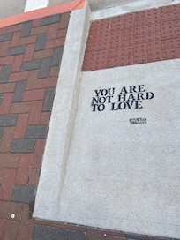 Words to live by are randomly painted on the street.