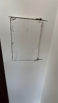 Random hole in wall with no attempt to cover it up or fix it.