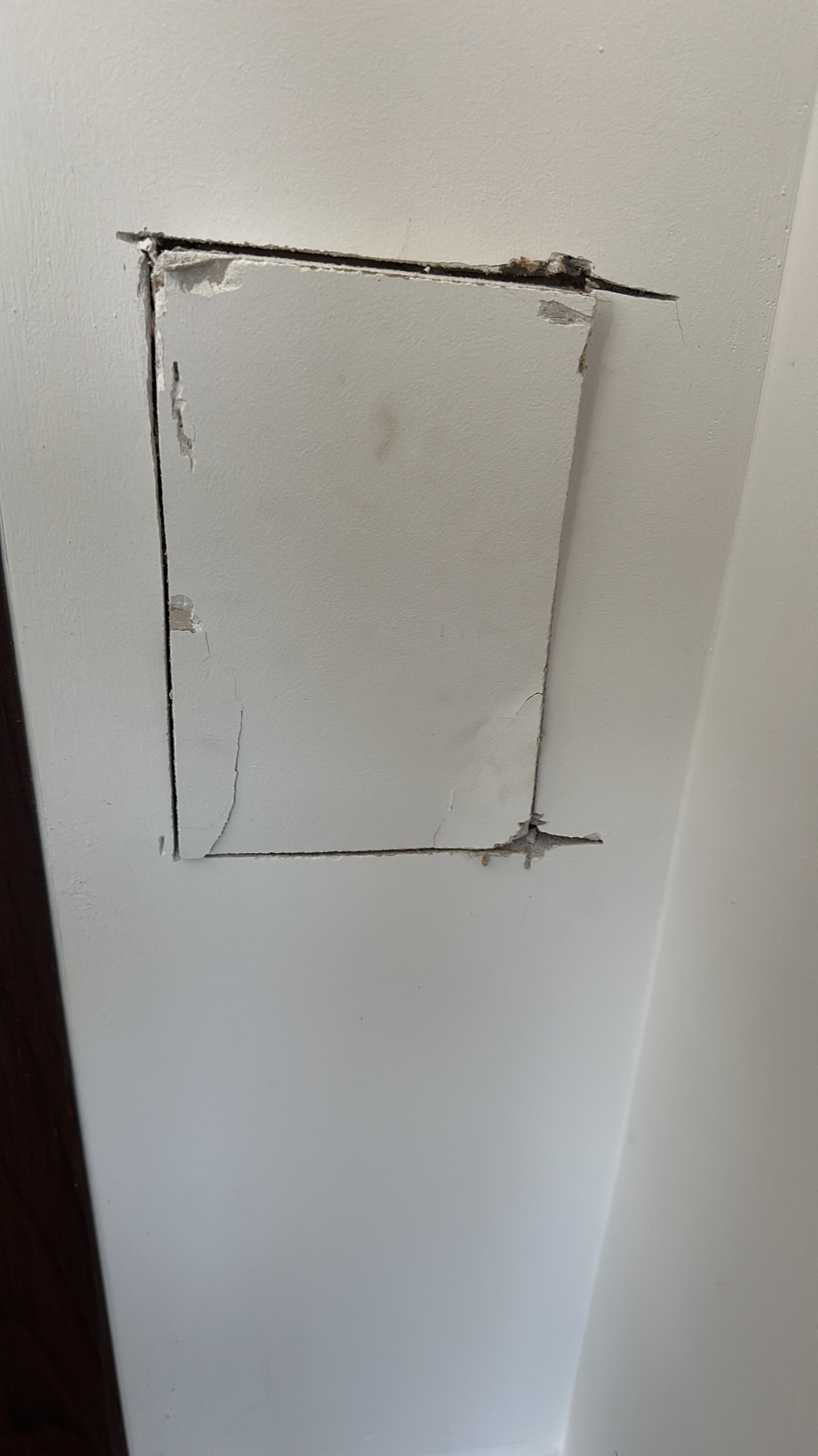 Random hole in wall with no attempt to cover it up or fix it. 