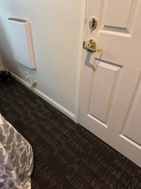 Less than 3ft on either side of the bed. Just enough room to open the door.