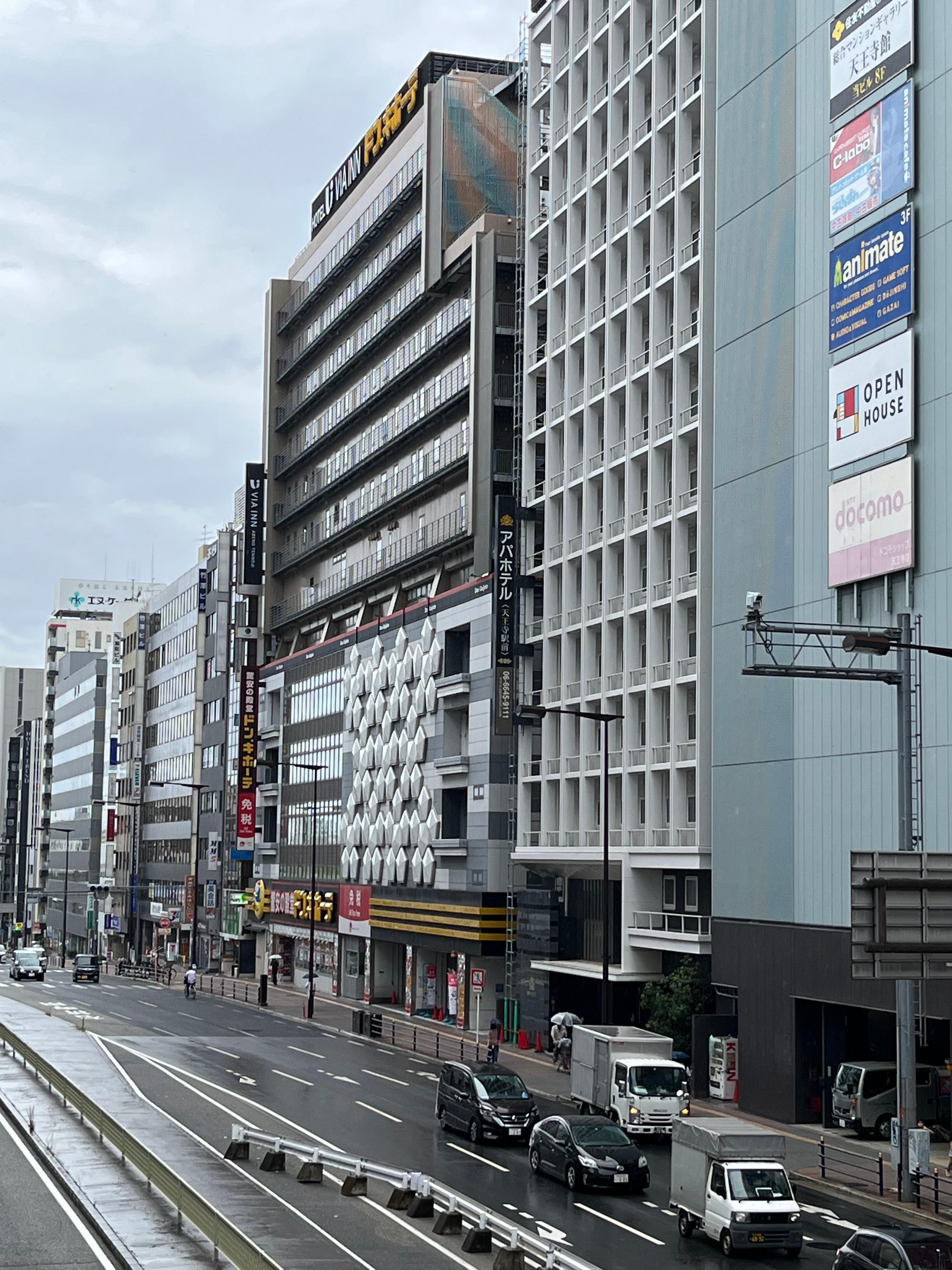 Hotel signage as viewed from the pedestrian overpass from the station. Look for the long thin vertical strip on the top left.