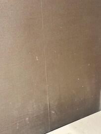 Water and white flecks all over walls in bathroom