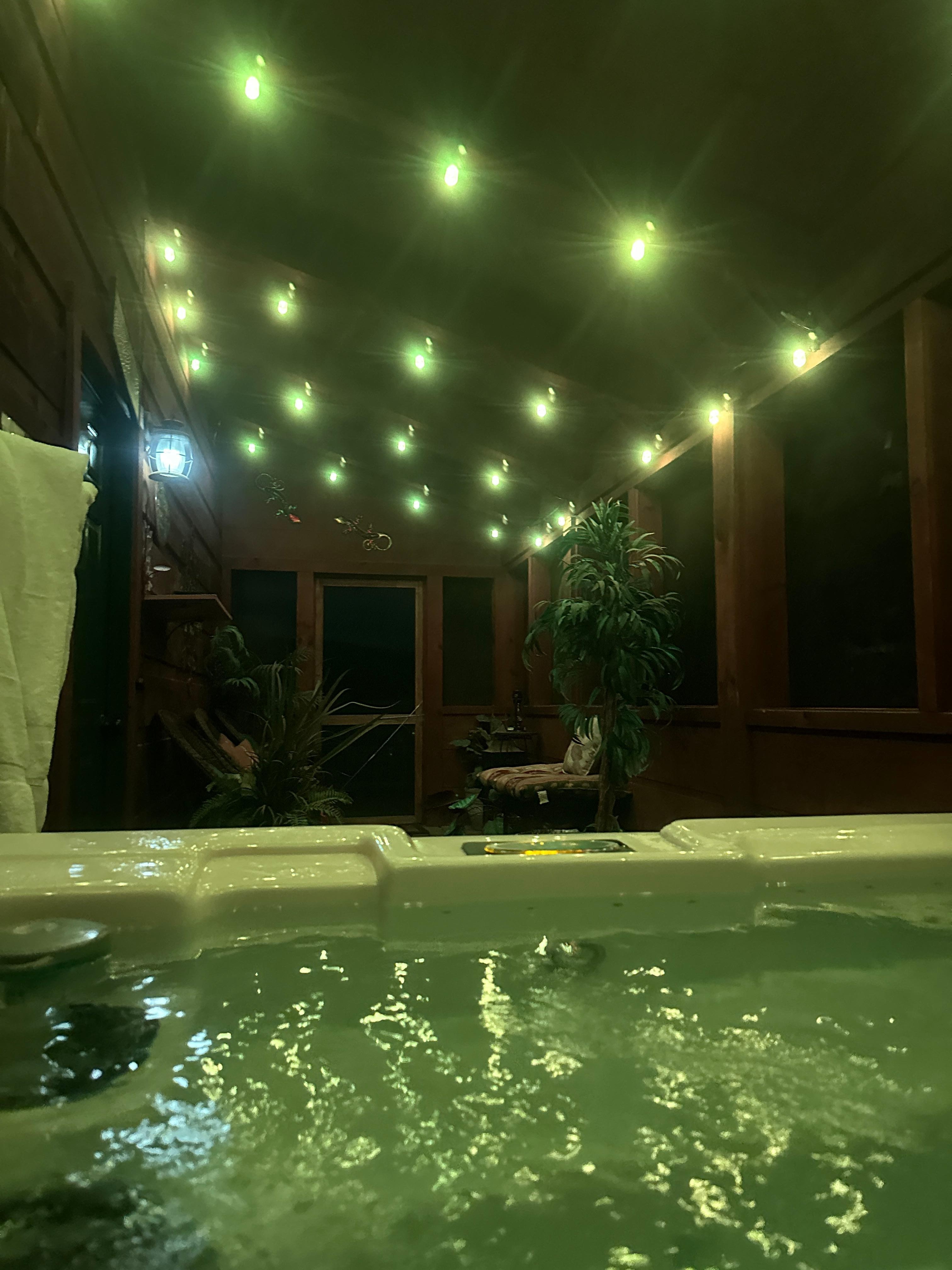 Hot tub in the evening in the screened in patio!  Amazing!