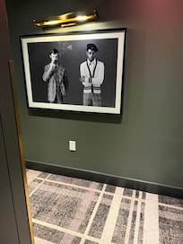 Nice carpet pattern and same pattern on clothes of people in photo. Nicely done.