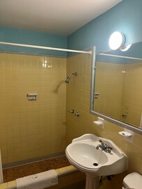 Shower head is set at about 4 feet - prepare to spend entire shower hunched over unless a child