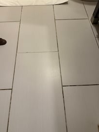 Sticky bathroom floor and filthy grout