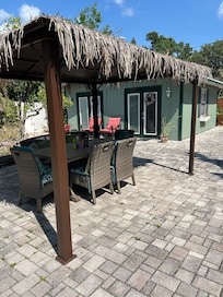 Outdoor seating with the pool house/studio living in the background