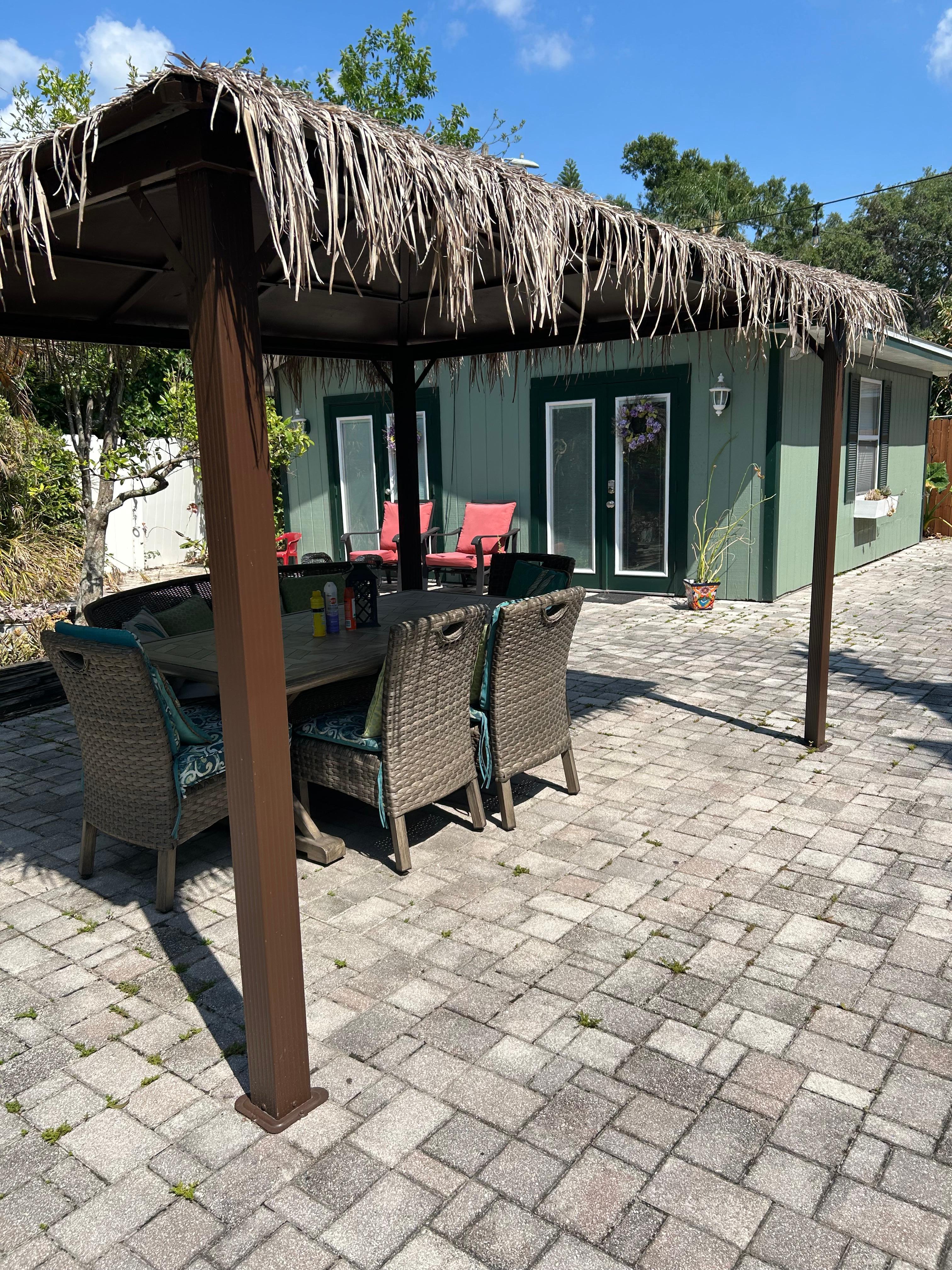 Outdoor seating with the pool house/studio living in the background 