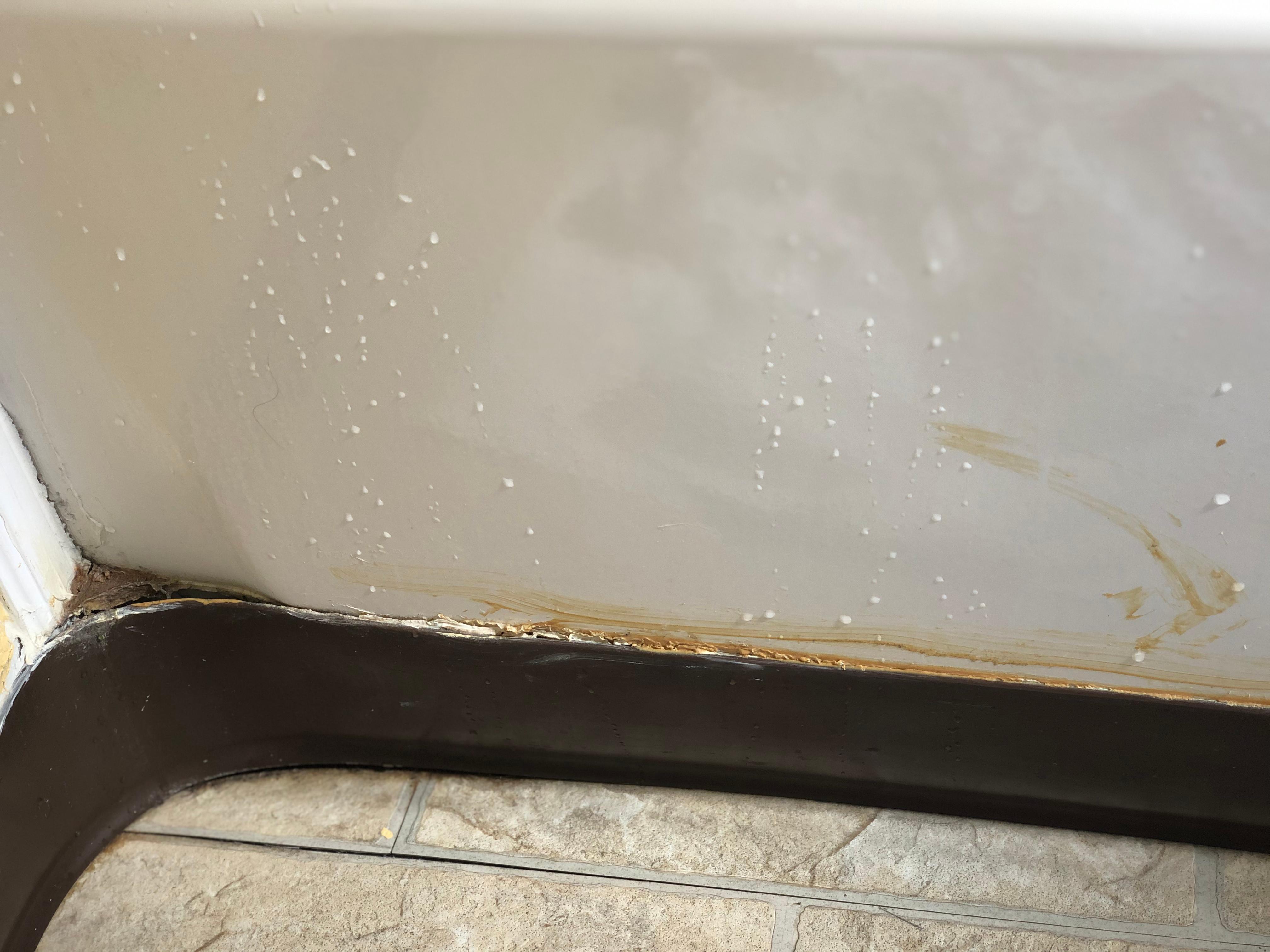 Tub with molding coming off and cracked caulking. 