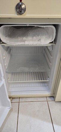 The fridge freezer was full of ice