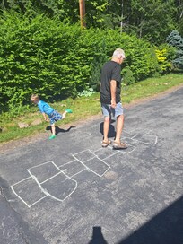 Great grandad and Jaxson play hop scotch.