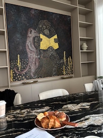 Cool wall hanging and dining table.