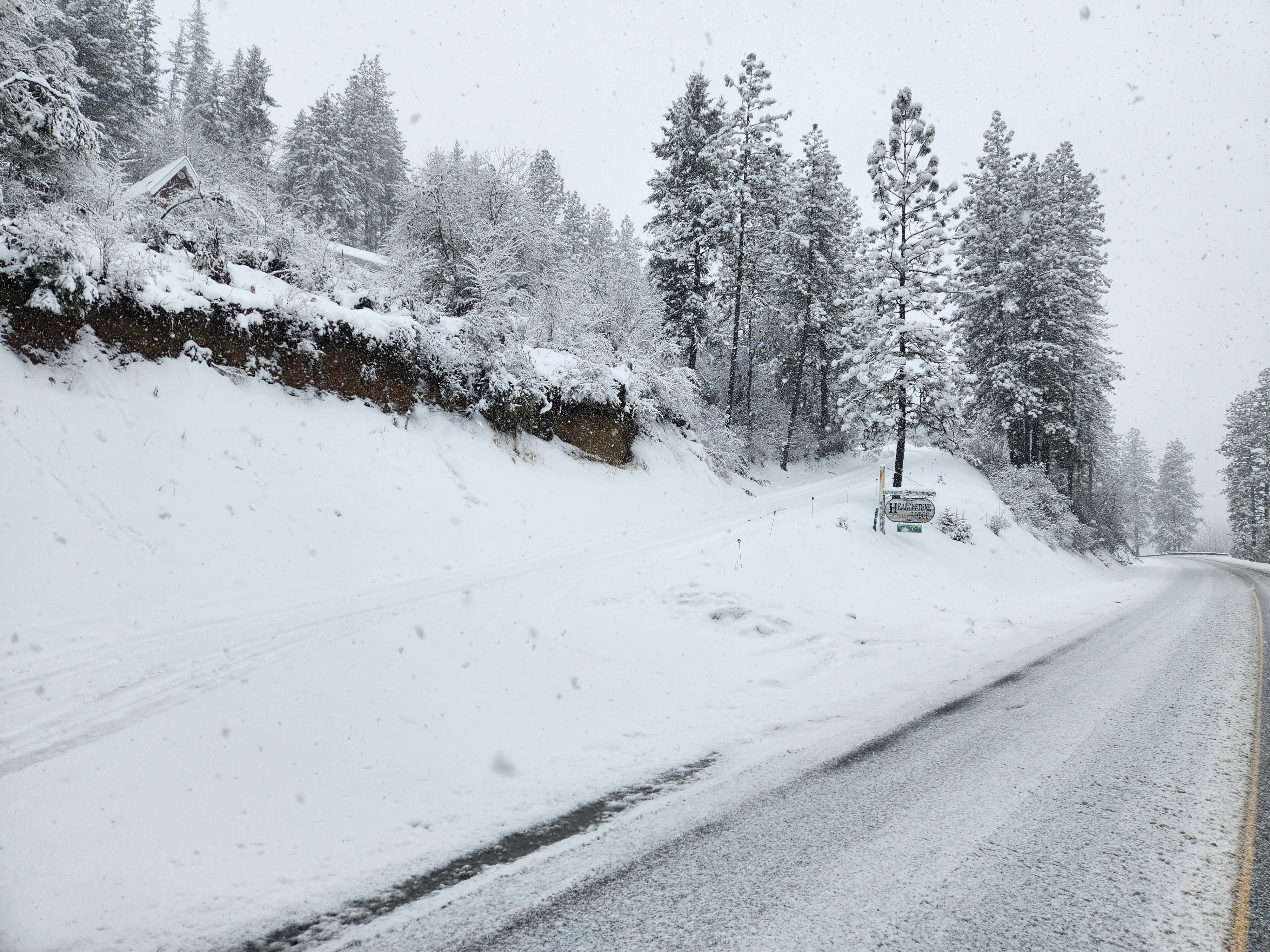 The entrance is left of the sign and the road switchbacks and gains steepness quickly.