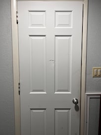 My best guess is this damage was sustained when someone tried to pound their way into the bathroom. Admittedly, that's a guess, but combine the damage with the finger smudges and it just paints an unsettling picture.