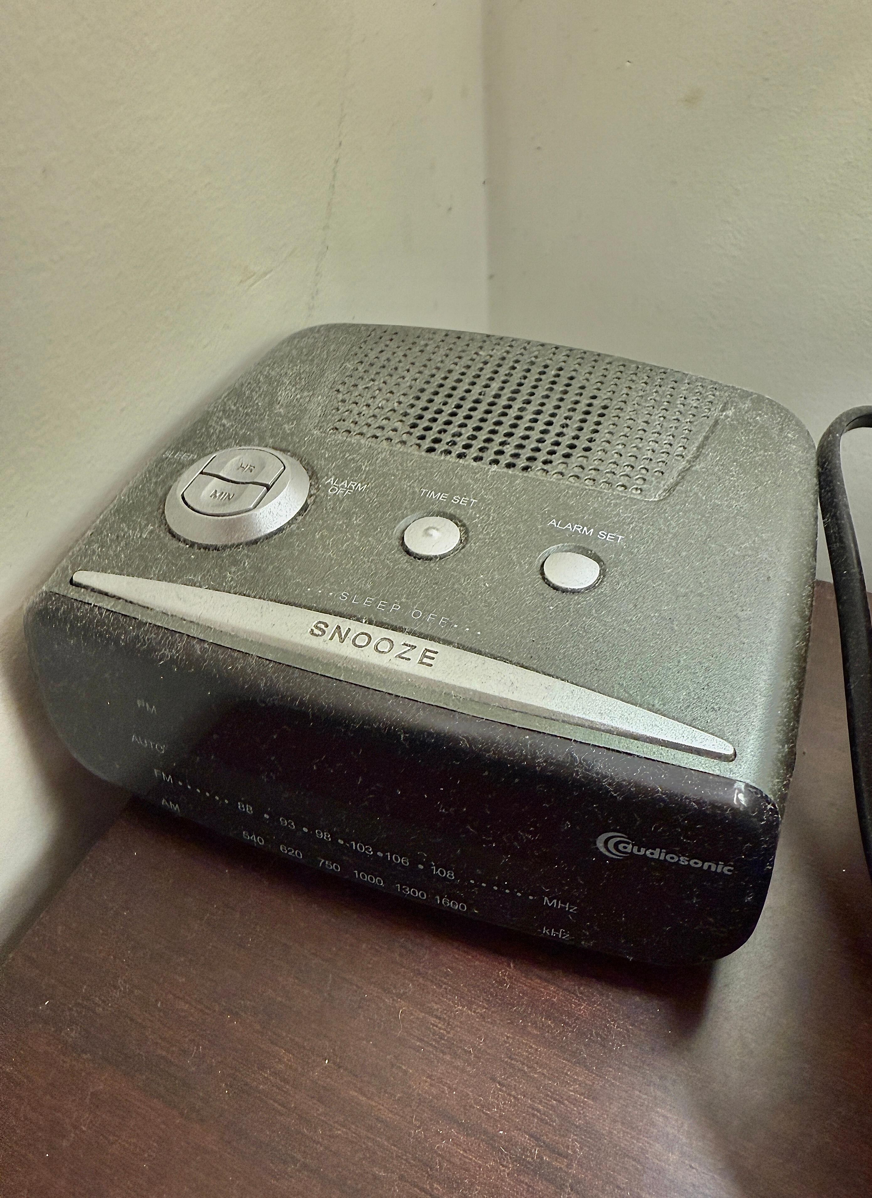 Dust on beside table alarm clock 