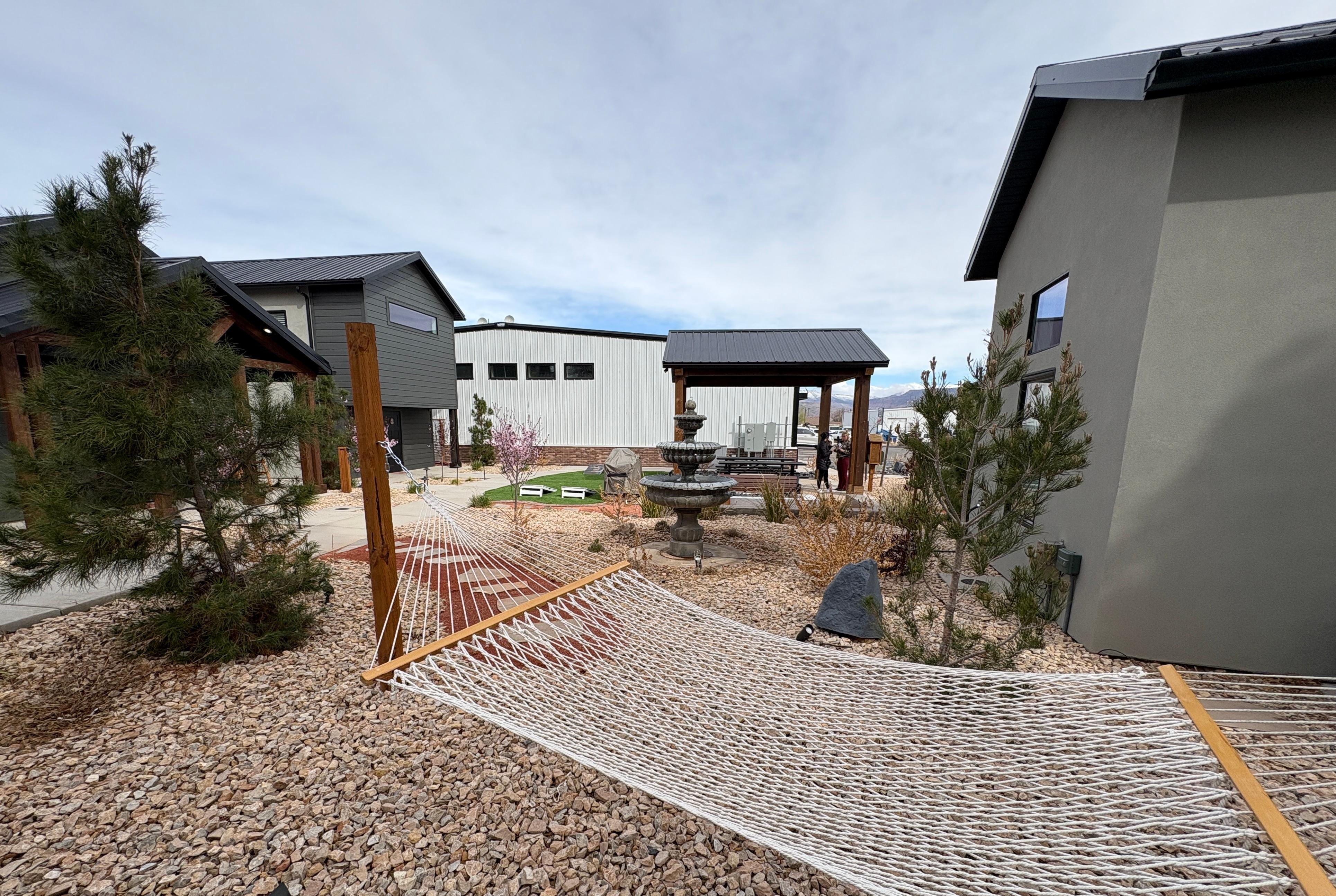 Peaceful Courtyard with yard games, BBQ grill, picnic bench, and lending library 