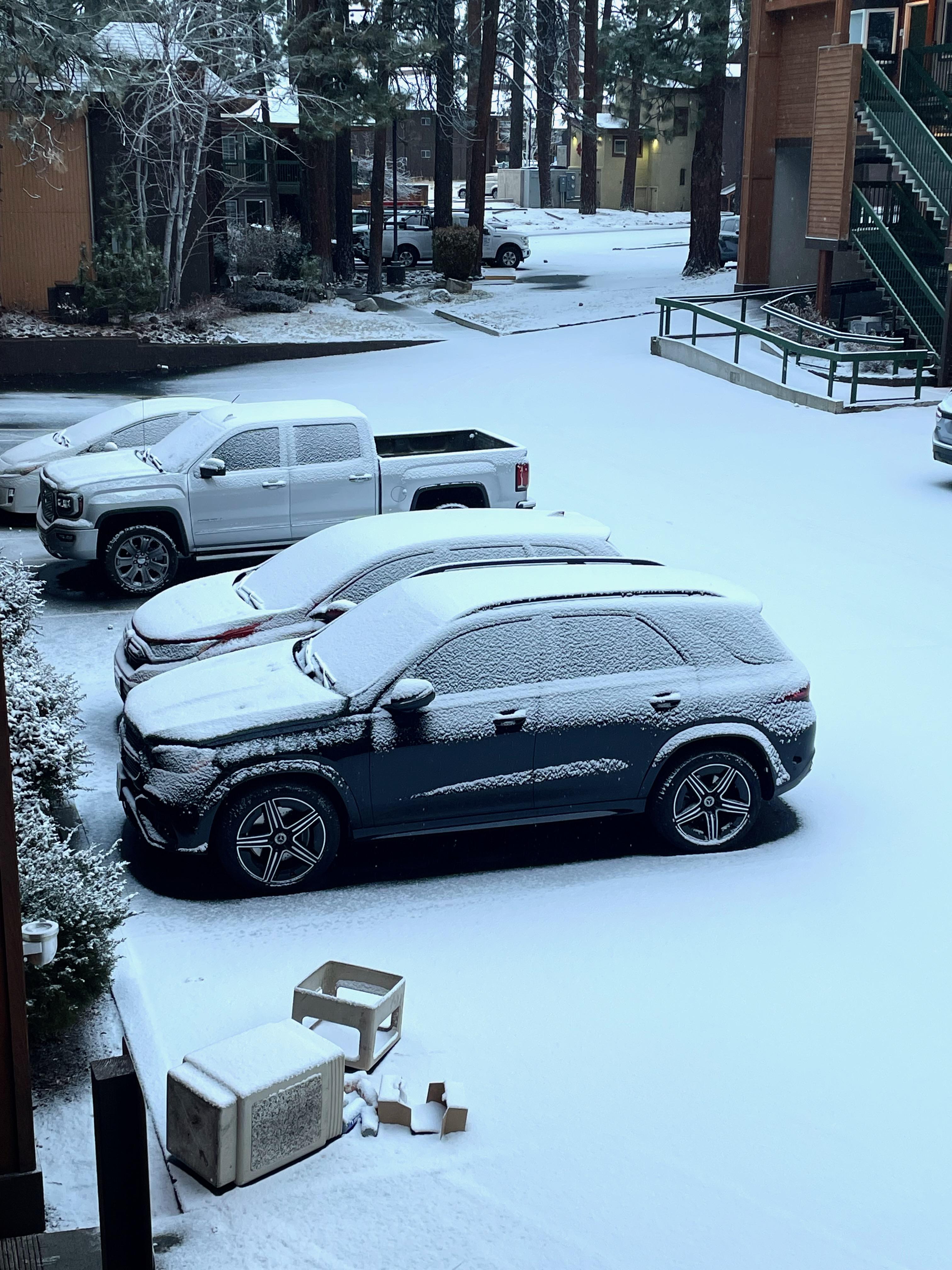 Snow in the parking lot covering the tracks of the bear who may have visited the trash