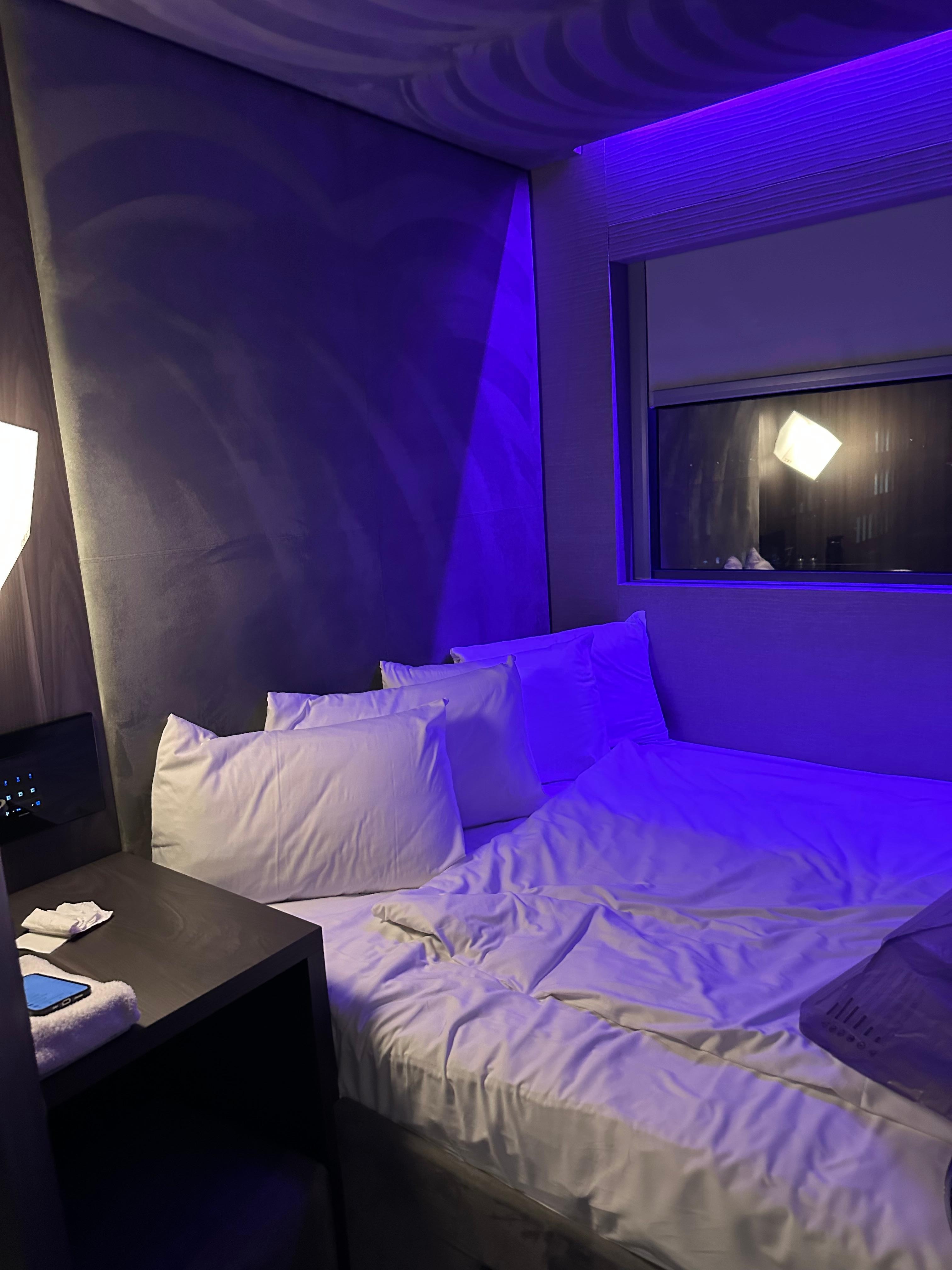 This is a queen bed configuration built into an alcove with one nightstand and a large window