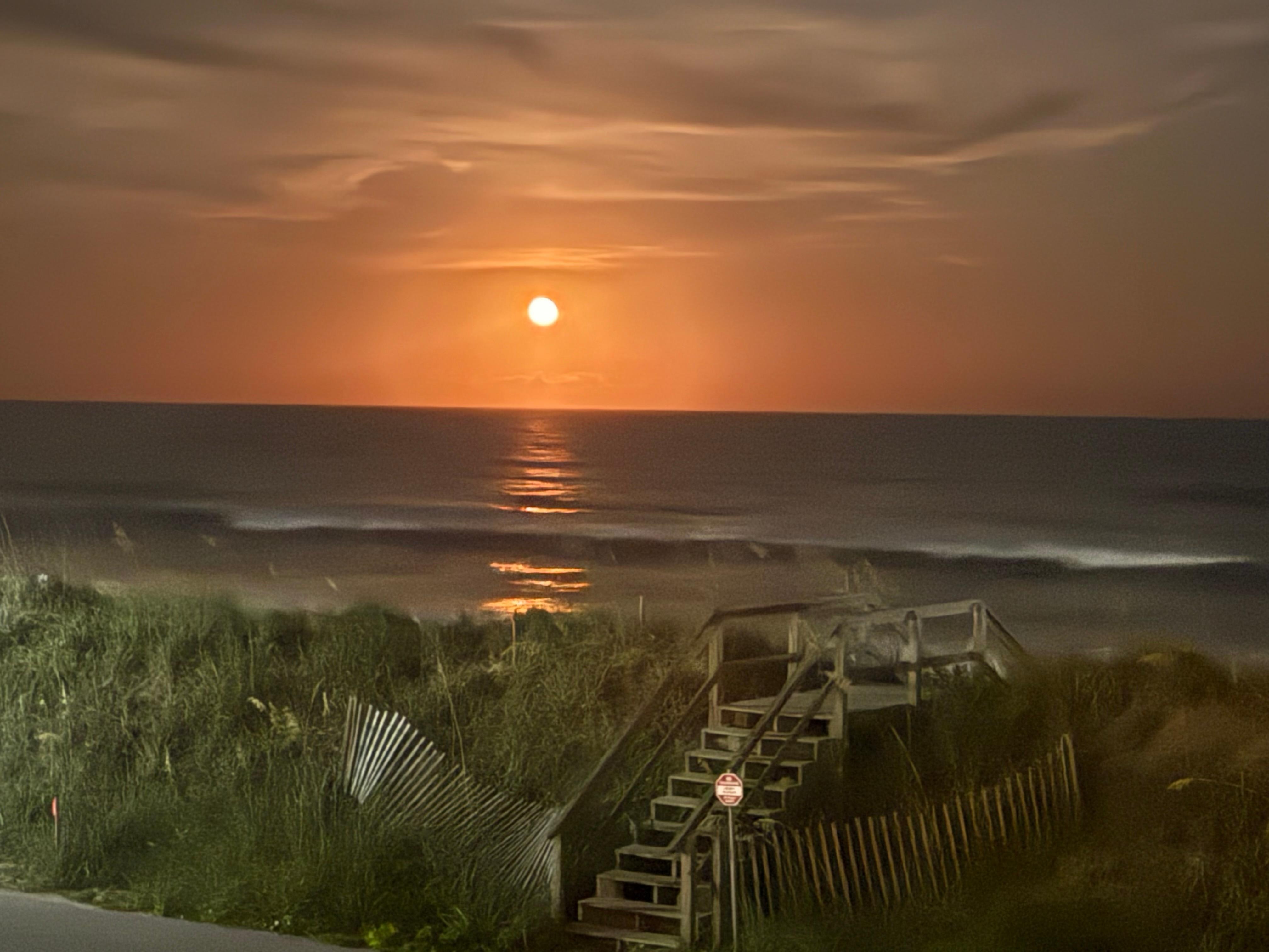 Watched red moon rise over ocean from deck. 
