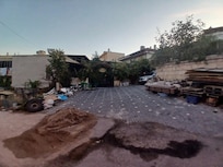 Construction material and load of gravel at entrance.