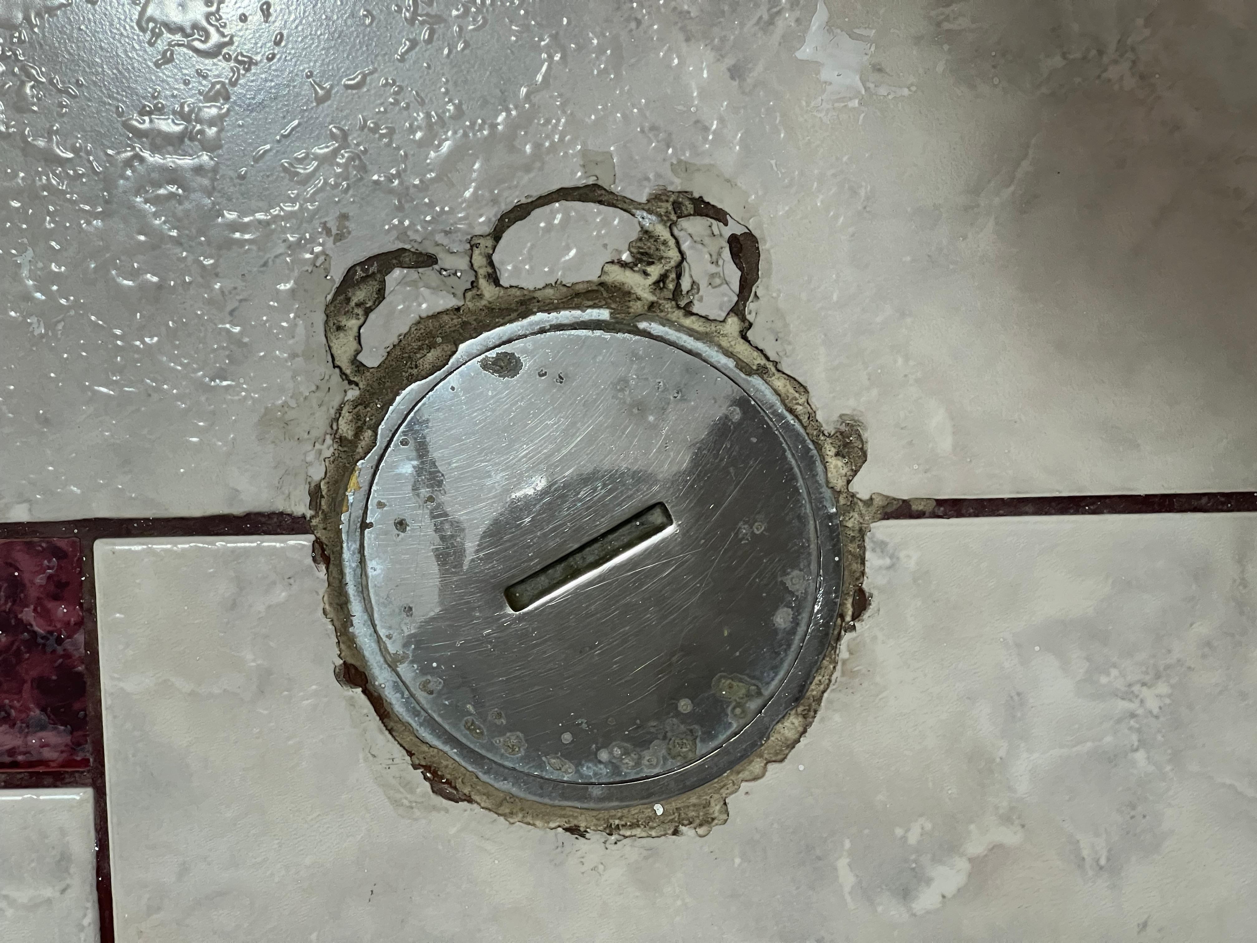 Drain in front of bathroom sink