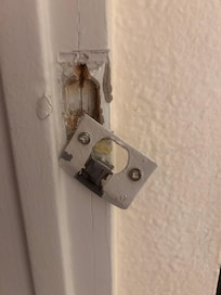 Door latch hanging loose.
