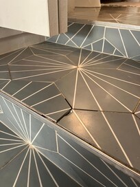 Broken tile on steps accessing washer and dryer