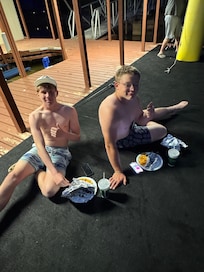 On the dock eating some striper they catch out on the boat.