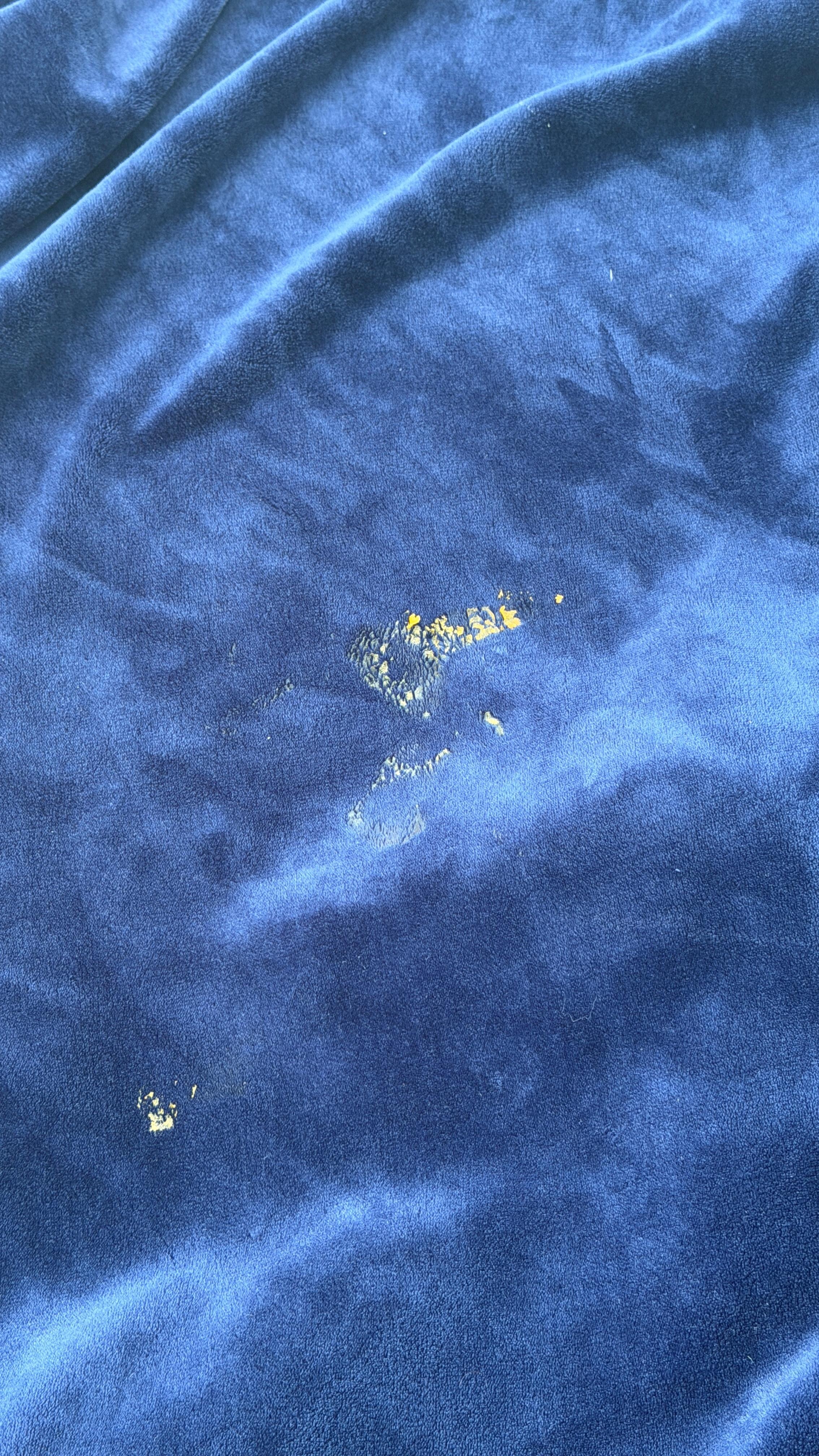 Who knows what this is on the throw blanket from the sofa.