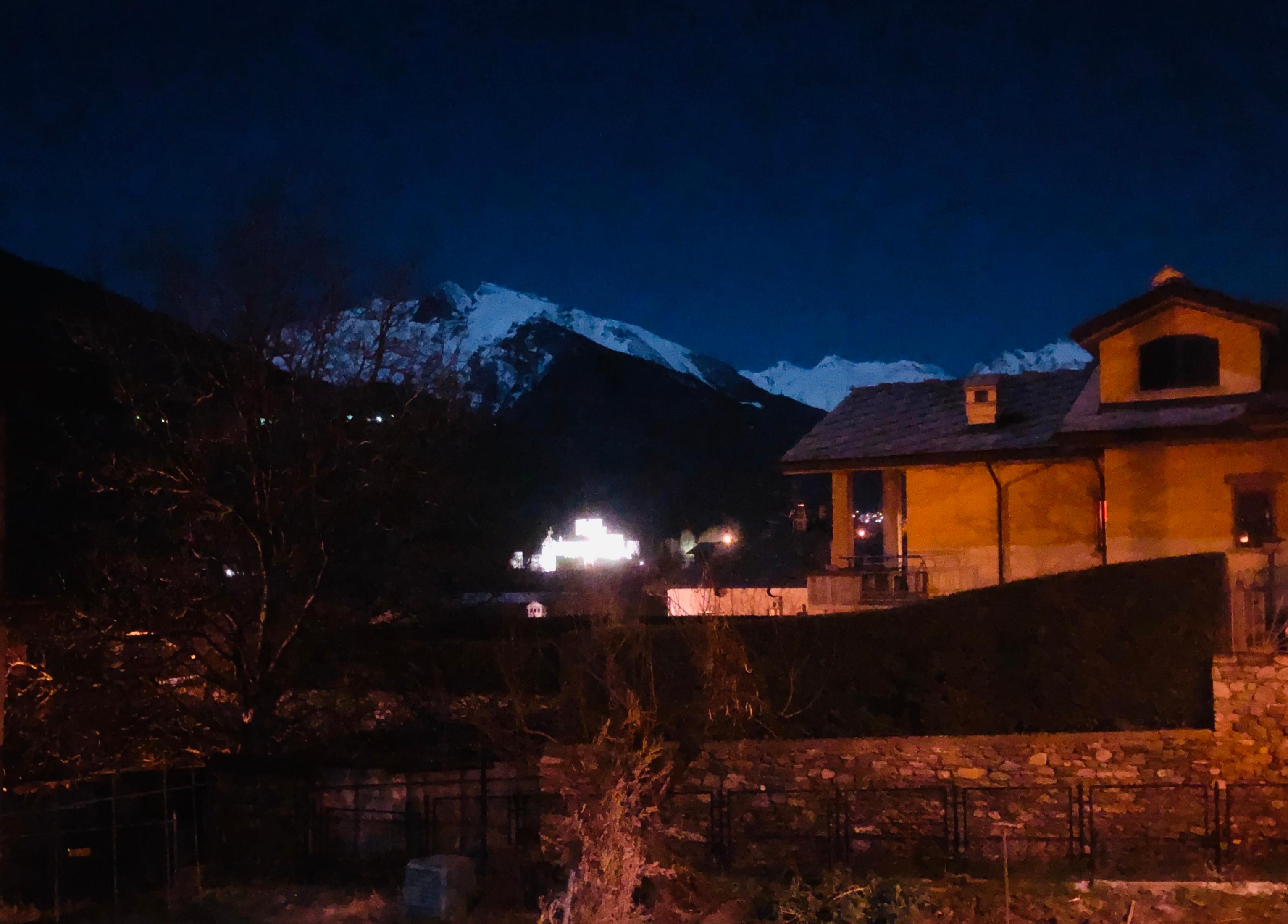 The full Wolf moon reflecting on snow covered mountains in St Pierre