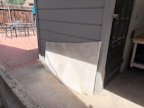 Pathway from front door to patio seating area had this broken piece of granite Precariously leaned up against the wall