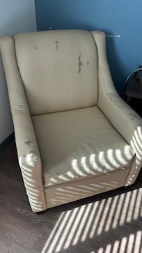 Torn filthy chair in room. Sums it up