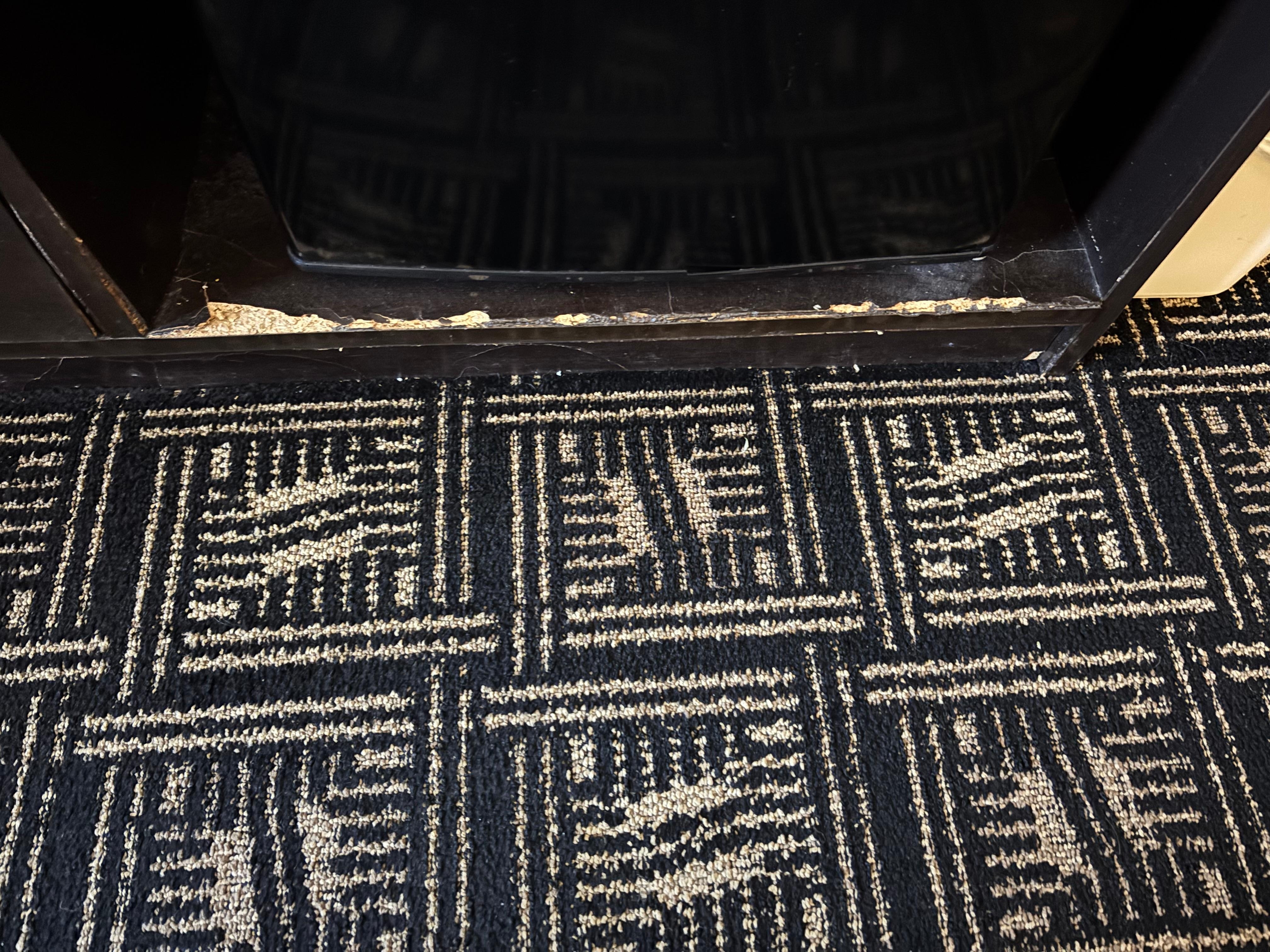 wood worn and a mess in front of the  refrigerator