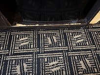 wood worn and a mess in front of the refrigerator