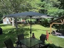 Backyard with pool in back. Nice deck in front and covered seating area with fire pit to side