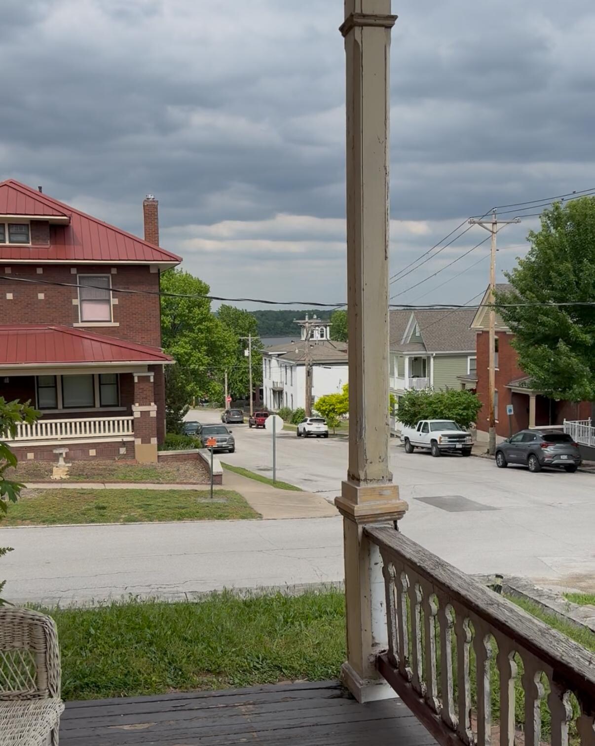 Front porch view. It was described on website as a beautiful view of the Mississippi river. In the bottom right corner, you can see a hole in the porch flooring.