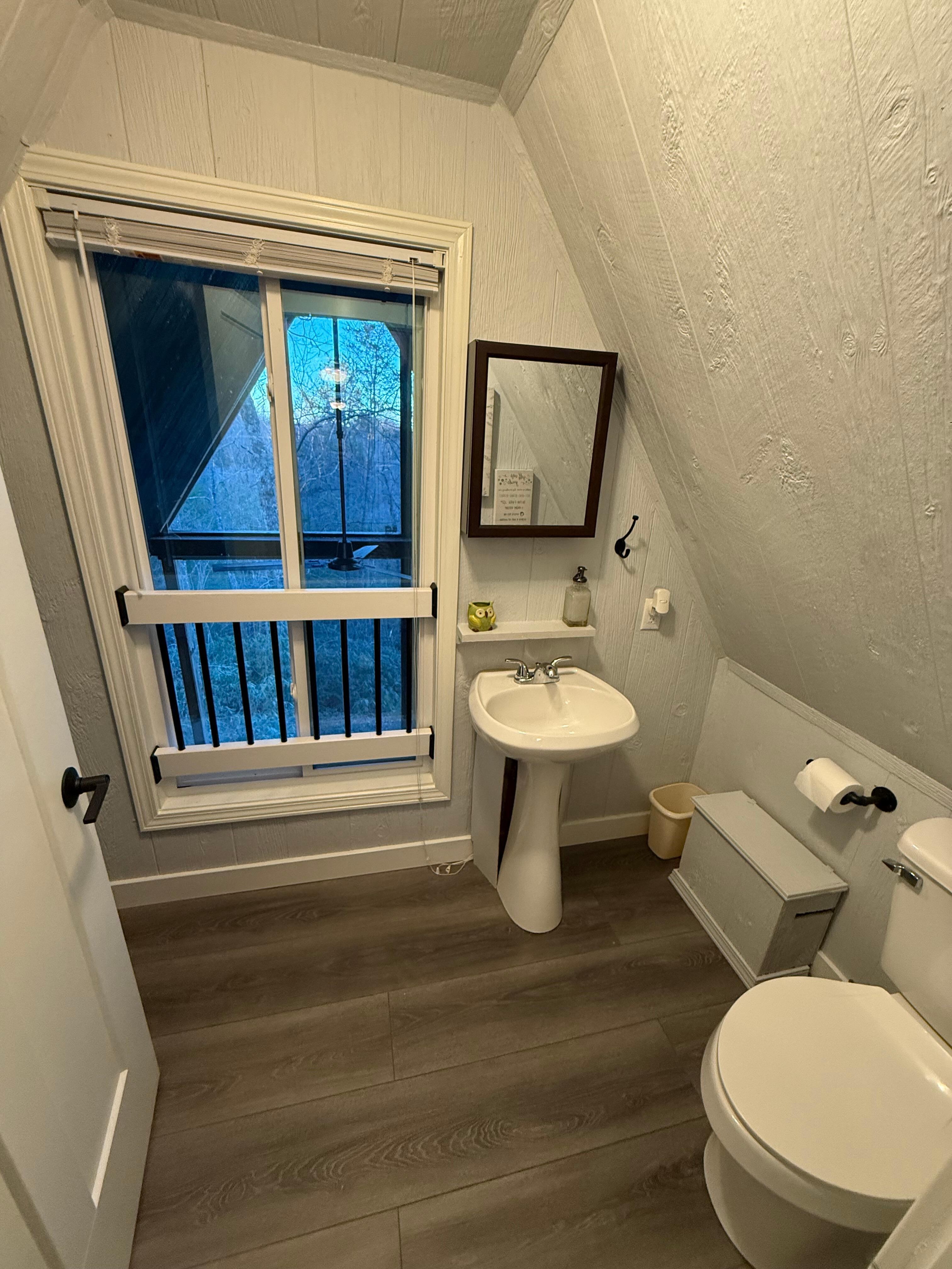 Half bath overlooking the back porch.