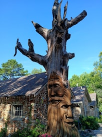 Carved tree in front of cottages